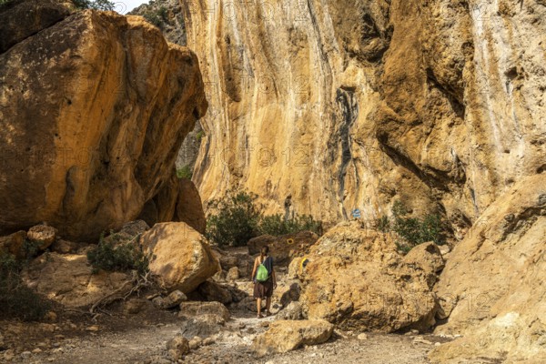 Tourist on the hiking trail through the gorge of Lissos near Sougia, Crete, Greece, Europe