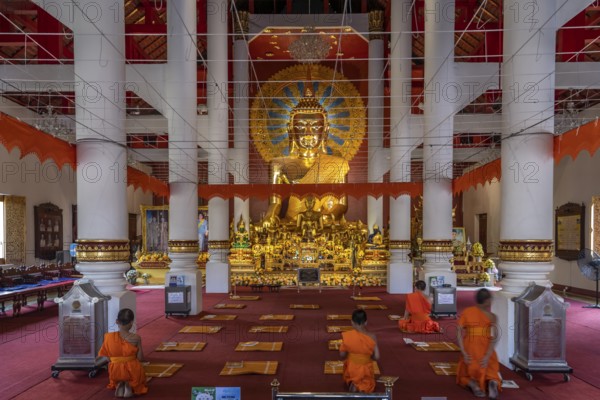 Novices praying in the Buddhist temple Wat Phra Singh, Chiang Mai, Thailand, Asia