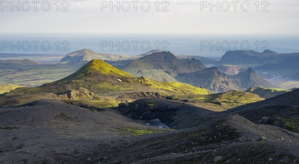 Volcanic mountain landscape overgrown with moss, atmospheric mountain landscape in the evening