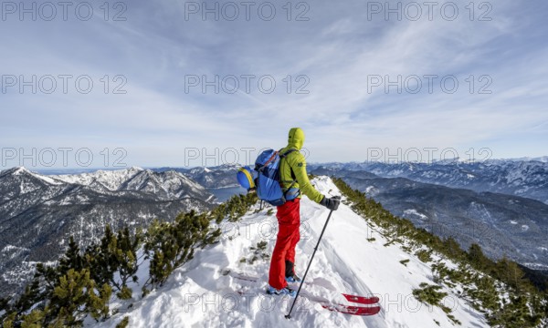 Ski tourer at the summit of Simetsberg, mountain panorama, Estergebirge, Bavarian Prealps, Bavaria
