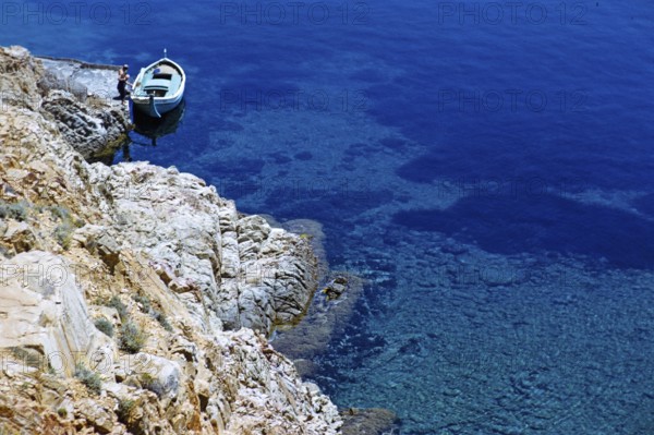 Blick auf kleine offene Boote, die an der Küste des tiefblauen Meeres vertäut sind, Insel Ibiza,