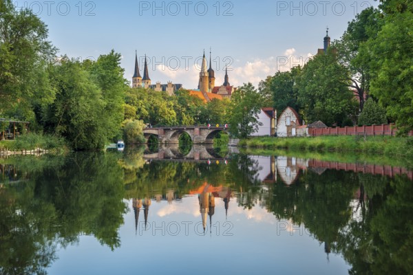 Merseburg Cathedral and Merseburg Castle reflected in the river Saale in the morning light,
