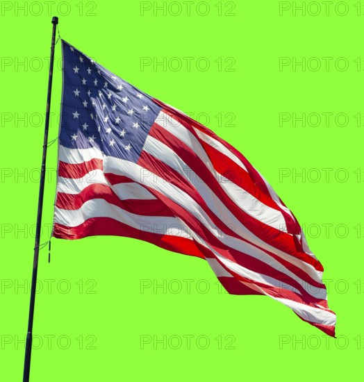 American flag waving in the wind on a flag pole over a green screen