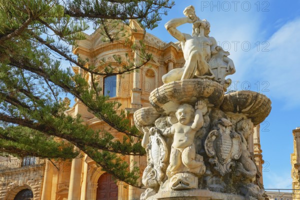 View of Hercules fountain and San Domenico church in the background, Noto Valley, Sicily, Italy,