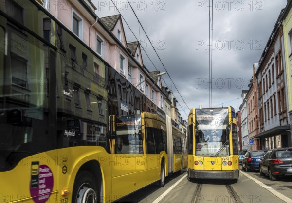 Tram and bus in traffic, on the street Schonnebeckhöfe in Essen-Katernberg, North Rhine-Westphalia,