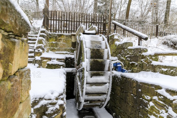 Small overshot waterwheel in the snow, Zschonermühle, Ockerwitz, Dresden, Saxony, Germany, Europe