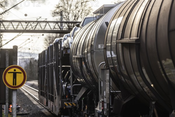 Goods train travelling on the winding Schuster Railway, overhead lines and infrastructure. Tank