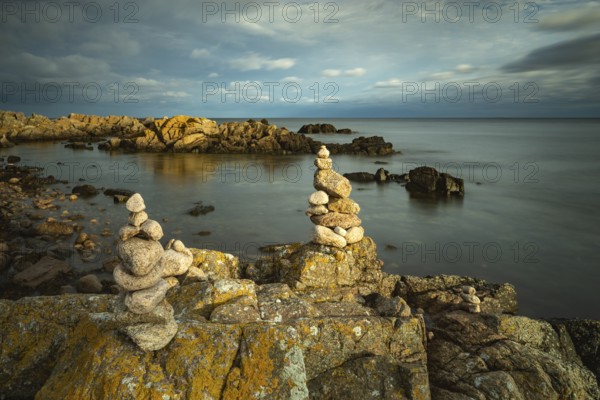 Rocky coast with cairns in the morning light, Allinge-Sandvig, Bornholm, Denmark, Europe