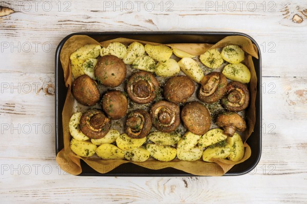 Champignon mushrooms and tender potatoes are seasoned with herbs and roasted to perfection on a