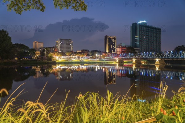 Chiang Mai skyline reflected in the Mae Nam Ping River at dusk, Chiang Mai, Thailand, Asia