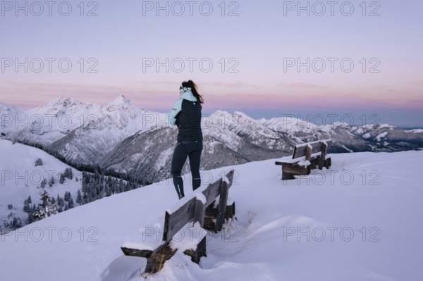 Hiking in the snow in the snow-covered winder landscape in the Alps at Neunerköpfle in the