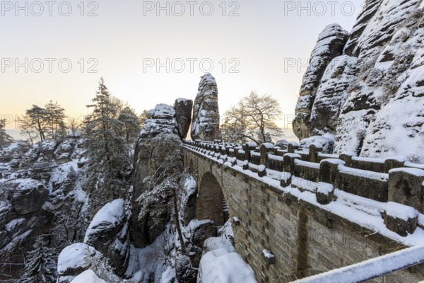 Snow on the Bastei bridge, rock gate and rock castle Neurathen in the morning, Saxon Switzerland,