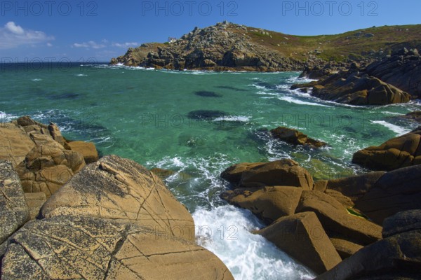 Lighthouse house Phare du Millier on cliff overlooking the sea under a clear sky, Point du Millier,