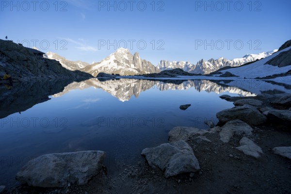 Mountain landscape in the evening light, water reflection in Lac Blanc with mountain hut Refuge du