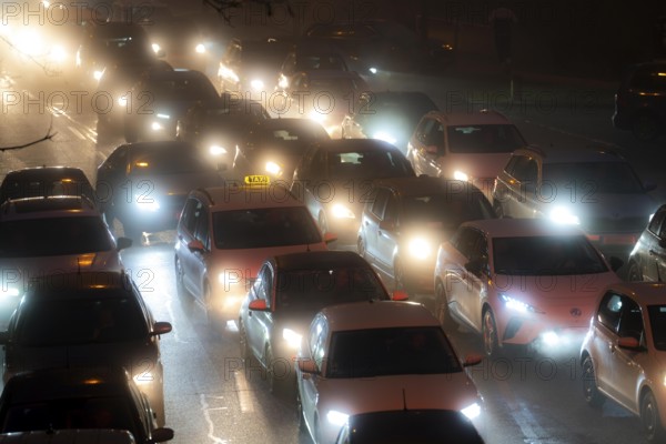 Dense fog, with visibility sometimes less than 100 metres, city centre traffic during rush hour at