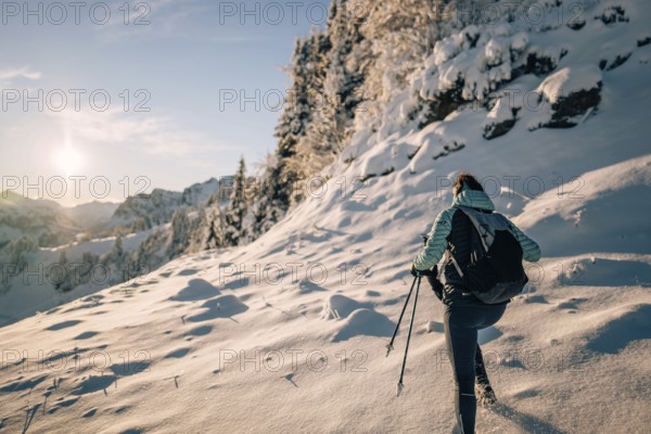 Hiking in the snow in the snow-covered winder landscape in the Alps at Neunerköpfle in the