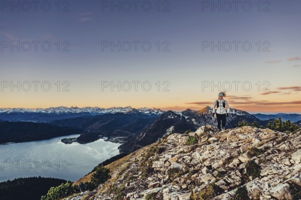 Trail running in autumn on the Jochberg on Lake Walchensee against the wonderful backdrop of the