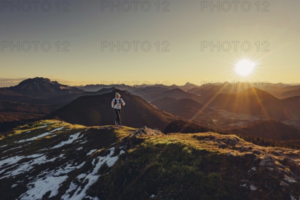 Trail running in autumn on the Jochberg on Lake Walchensee against the wonderful backdrop of the