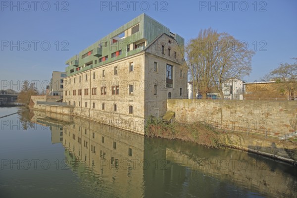 Historic Karlshospital built in 1721 and former penitentiary on the river Fulda, baroque, modern