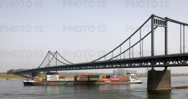Krefeld, North Rhine-Westphalia, Germany - Cargo ship crosses the Rhine under the Krefeld-Uerdingen