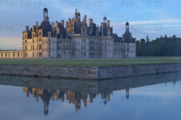 Chambord Castle with moat at sunrise, Chambord, Department Loir-et-Cher, Centre region, France,