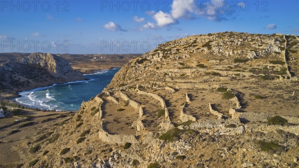 Drone shot, archaeological site, coastal landscape with ruins, sea view and blue sky, ruins of an