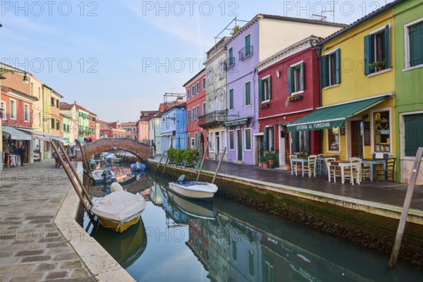 Colorful houses and a bridge 'Ponte - Fondamenta San Mauro' going over the waterway with boats