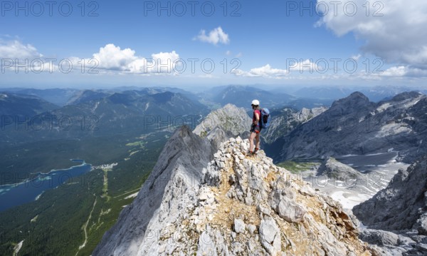 Mountaineer with helmet on a mountain ridge, ascent to the Zugspitze, Zugspitze via ferrata,