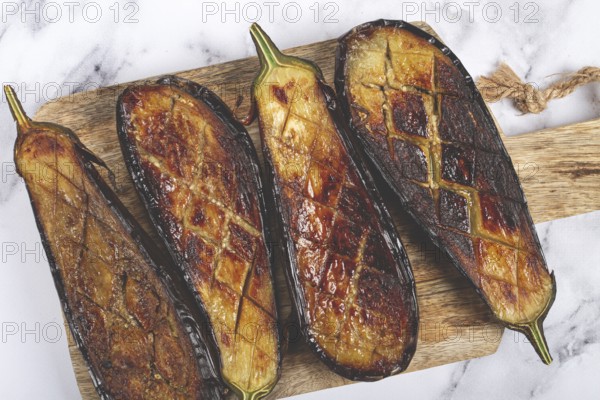 Sliced fried eggplant, on a chopping board, top view, homemade, no people