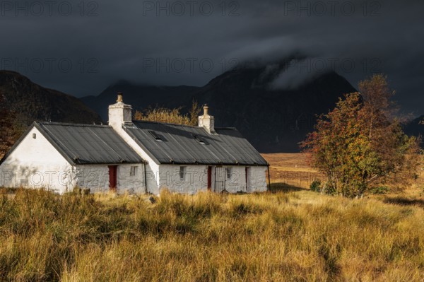 Cottage in front of mountains, cloudy mood, autumn, Blackrock Cottage, Glencoe, Scottish Highlands,