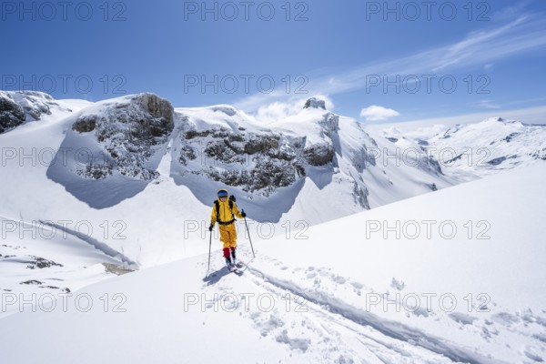 Ski tourer in mountain landscape with snow, ascent to Wildstrubelhütte, Bernese Alps, Switzerland,