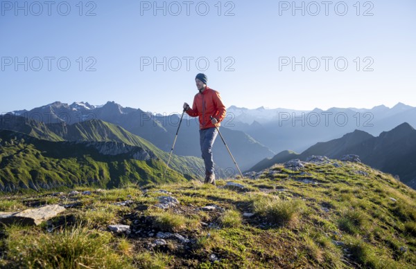 Hiker enjoying the mountain panorama in the morning, Venediger group, behind Dreiherrenkopf,