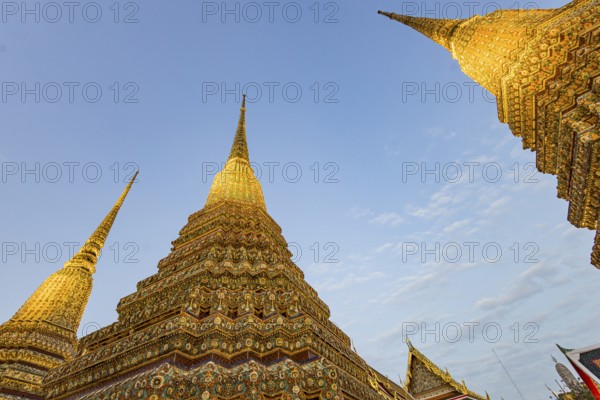 Wat Pho temple at sunset. Bangkok's oldest Buddhist monastery near the Grand Palace. Four chedis