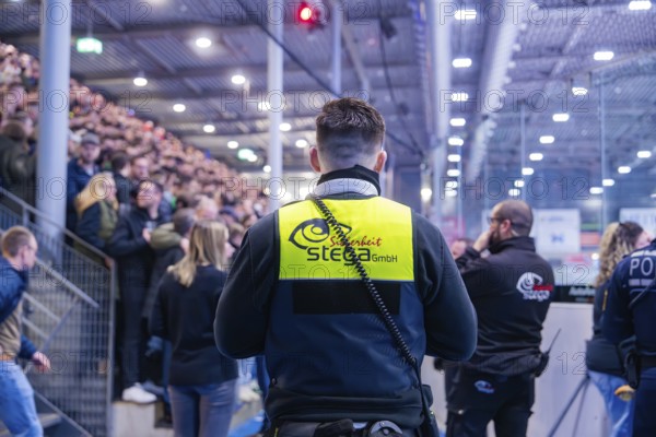 Security personnel monitor a large crowd in a crowded arena, Heilbronn Falken Vs Bietigheimer