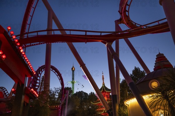 Roller coaster, chain carousel and pagoda at night, Tivoli Amusement and Recreation Park,