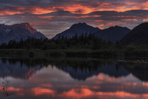 Mountains reflected in lake, sunset, cloudy mood, alpenglow, summer, seven springs, behind