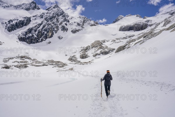 Woman hikes across a snowfield, Glaciar Vinciguerra, Ushuaia, Tierra del Fuego Province, Argentina,