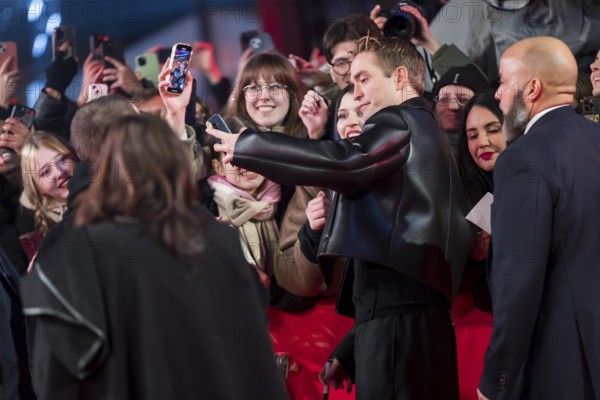 Robert Pattinson takes selfies with fans on the red carpet at the Special Gala of the film Mickey