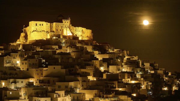 Full moon night over an illuminated settlement with castle, dramatic lighting, Querini Castle,
