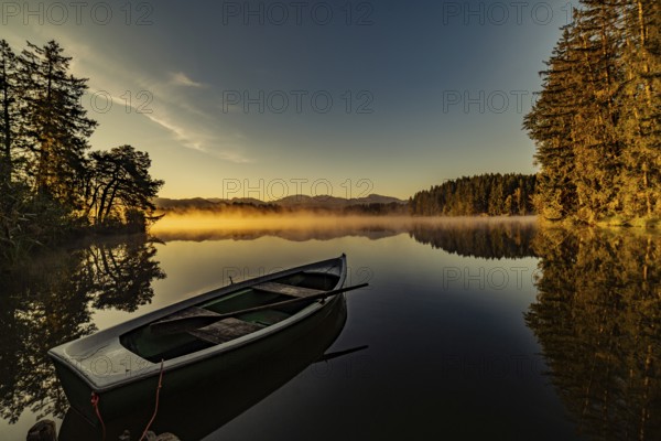 Boats in the autumnal Schmutter Weiher in the Allgäu near the municipalities of Halblech,