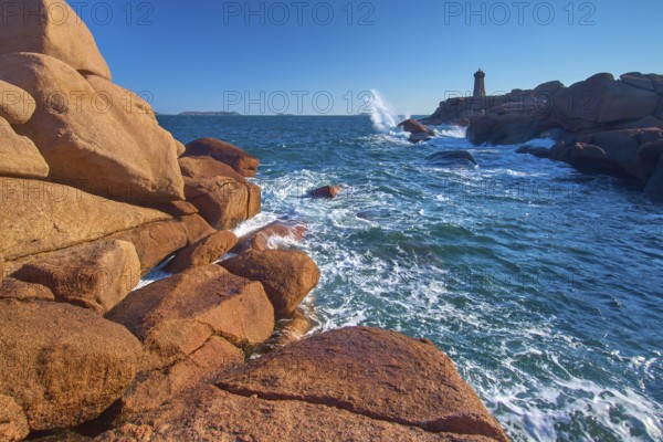 Lighthouse, Phare de Mean Ruz or Phare de Ploumanach, in the foreground rocky coastal landscape,