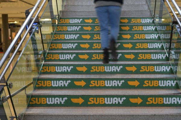Advertising for a fast food restaurant on the stairs at the main railway station, Nuremberg, Middle