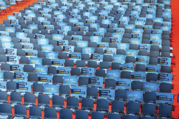 Assembly hall, deserted with many empty chairs and posters with the inscription UNSER KANNZLER.