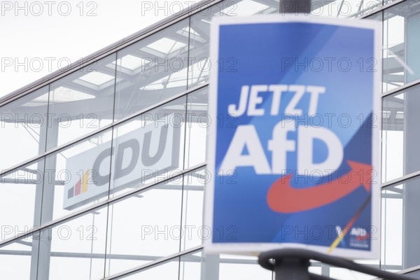 An election poster of the far-right AfD party (now AfD) hangs in front of the CDU logo in front of