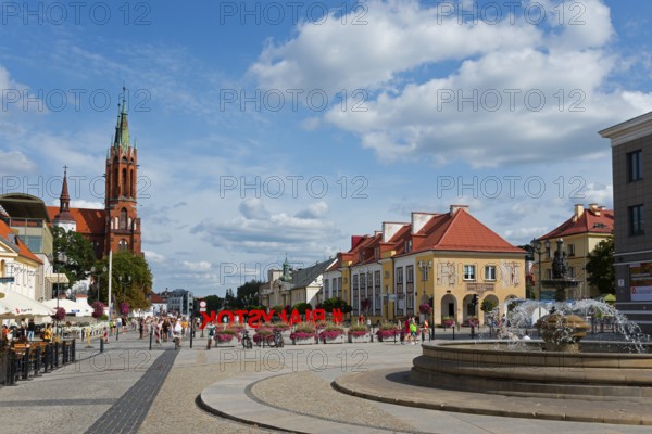 Urban street scene with church, colourful buildings and a fountain, Kosciuszko Market Square,