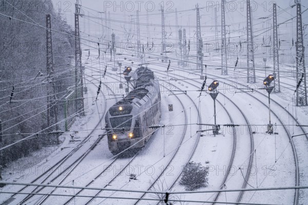 Winter weather, heavy snowfall, railway tracks in front of Essen central station, local train,