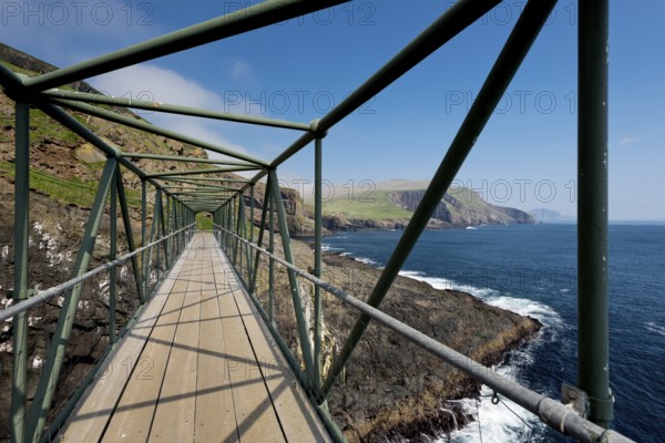 So-called Atlantic Bridge, pedestrian bridge over rock crevice Hólmgjógv, Mykines, Útoyggjar, Faroe