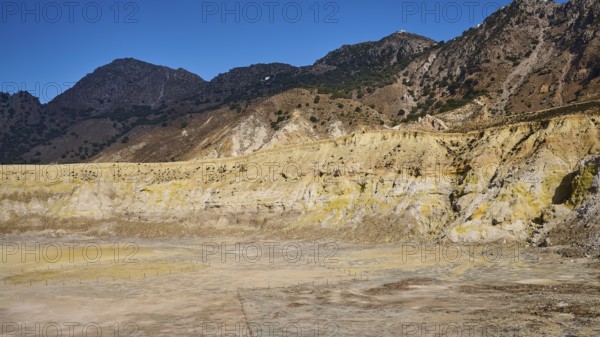 Barren volcanic crater landscape with mountains under a clear blue sky, volcanism, volcanic island,