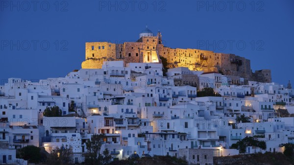 Night view of an illuminated castle above white houses with blue evening lighting, Querini Castle,