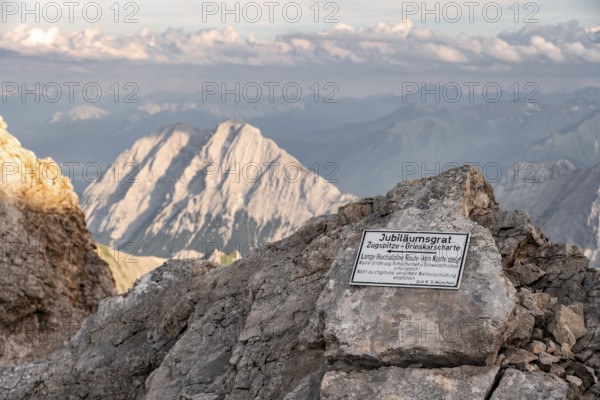 Signpost for difficult mountain tour, signpost Jubiläumsgrat in the evening light, steep rocky